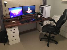 a computer desk with two monitors and a keyboard