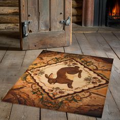 an animal rug is on the floor next to a door and fire place in a log cabin