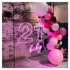 a pink and gold 21st birthday balloon arch with the number twenty one baby on it