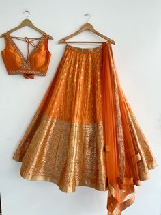 an orange skirt and bra hanging on a wall