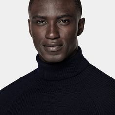 This navy turtleneck sweater is tailored to a slim fit and features a ribbed texture, raglan long sleeves, and ribbed hem and cuffs. Casual Ribbed Collar Turtleneck For Work, Casual Turtleneck With Ribbed Collar For Work, Ribbed Turtleneck Outerwear For Work, Navy Fitted Sweater For Winter, Navy Turtleneck Top For Fall, Classic Turtleneck Sweater With Ribbed Neckline, Wool Turtleneck With Ribbed Collar For Winter, Workwear Funnel Neck Sweater With Ribbed Neckline, Winter Turtleneck With Ribbed Funnel Neck