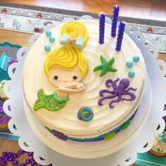 a birthday cake decorated with an image of a little mermaid and sea creatures on it