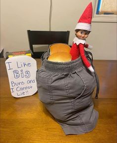 an elf sitting in a bag on top of a table