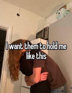 two people hugging each other in front of a refrigerator freezer with the words i want them to hold me like this