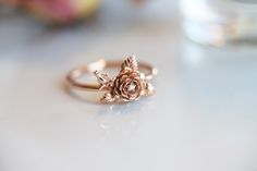 "\"ROSE\" A feminine and delicate rose flower ring with a tiny sparkle diamond. This flower ring is carved from wax by our Master Wax Carver, Somkeit then cast into 14k gold. The flowers sit on top of the band, which makes this ring stackable. You can choose between 2 flowers or 1 flower(without the flower bud). ---------------------- { n o t e } ➤ This ring is made to order, please allow 2-3 weeks for this ring to be handmade for you. Requested modifications are subject to revised production ti Rose Flower Ring, Rose Diamond, Stacked Wedding Bands, Gold Flower Ring, Gem Diamonds, Ring Hand, Rose Ring, Original Jewelry, Gold Flower