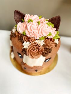 a close up of a cake on a table with frosting and flowers in it