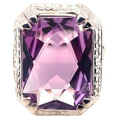 18K white gold filigree Art Deco ring featuring a large amethyst weighing 9.09 carats. This is the original stone, carefully re-polished in the same rectangular brilliant cut. The amethyst measures about 16mm x 12mm. The ring fits a size 7 finger and weighs 4.6dwt. It dates from the 1920's. The color is a bit lighter than the hand photos show when worn. Antique Cupboard, Hand Photo, Deco Ring, Gold Filigree, Ring Fit, Art Deco Ring, Amethyst Ring, Antique Rings, Cocktail Rings