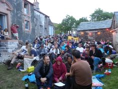 a group of people sitting in the grass