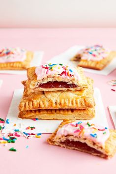 small pastries with pink icing and sprinkles