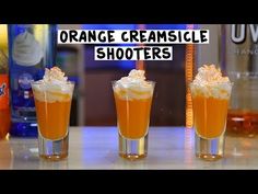 three shot glasses filled with orange creamsice shooters