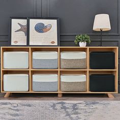 a wooden shelf filled with lots of different types of storage containers and pillows on top of it