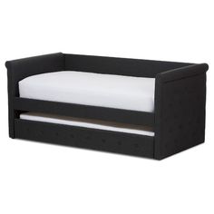 a black daybed with white sheets and pillows on it's sides, in front of a white background