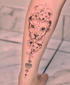 a woman's leg with a tattoo on it that has a lion and hearts