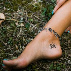 a woman's foot with a tattoo on it and a chain around her ankles