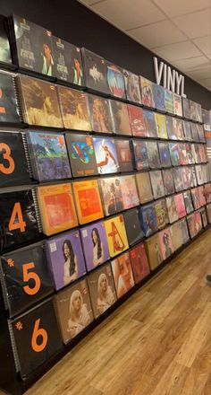 a wall full of vinyl records with numbers on them