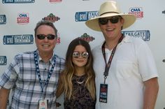 two men and a woman standing next to each other