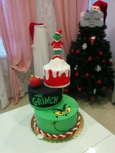 there is a christmas cake with the grin on top and santa's hat on top