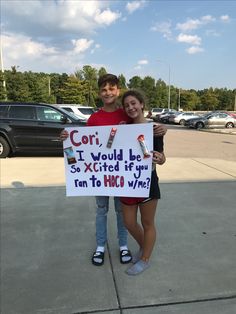 two people holding up a sign that says coir i would have sexed if you ran to hoo wine