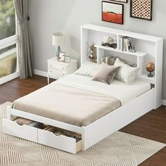 a white bed with two drawers underneath it