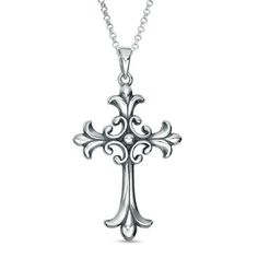 a silver cross necklace with filigrees is shown on a white background,