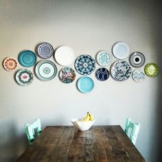 a wooden table topped with lots of plates on top of it's side wall