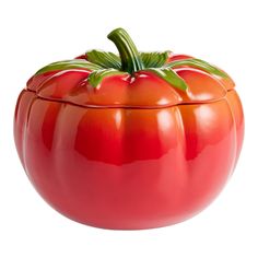 a large red tomato sitting on top of a white surface