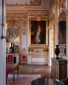 an ornately decorated room with paintings on the walls