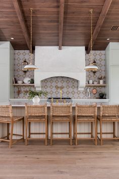 a kitchen with an island, stove and dining room table in the middle of it