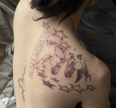 the back of a woman's shoulder with tattoos on her left arm and chest