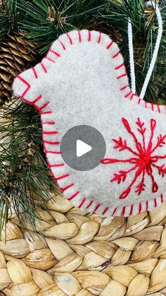 a felt bird ornament hanging from a christmas tree