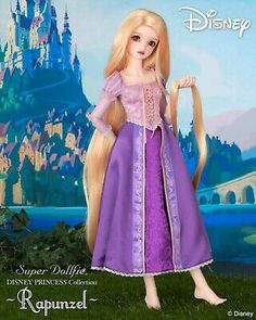 a barbie doll with long blonde hair and purple dress in front of a disney castle