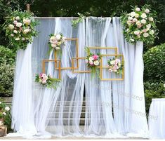 an outdoor wedding ceremony with white drapes and flowers