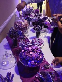 a table filled with lots of purple candy