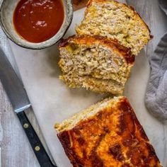 three slices of bread on a cutting board next to a bowl of ketchup