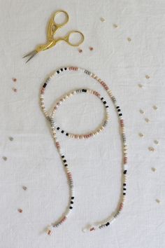 a pair of scissors and beads on a table