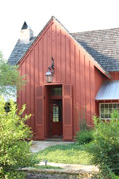 a red house with a light on the front door