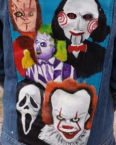 the back of a man's jean jacket with painted images of clowns on it