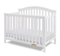 a white crib with no mattress in the front and side rails on the sides