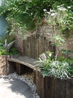 a wooden bench sitting in the middle of a garden