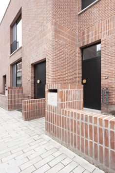 a brick building with black doors and windows