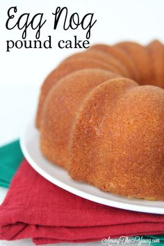 a bundt cake sitting on top of a white plate next to a red napkin