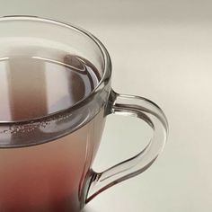 a glass cup filled with liquid sitting on top of a table