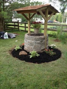 a small gazebo in the middle of some grass