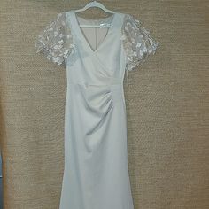 Nwt Eliza J Full Length Evening Gown Dress Size: 6 Cream/Tan/Beige Color Armpit To Armpit: 15.5" Flat Shoulder To Hem: 62" New With Tags, Crepe Material, Ruched At Waist, Darts At Bust, Hidden Back Zipper, Lined, Full Length, Puffed Short Sleeves With 3d Flowers, Excellent Condition, Smoke Free Home, Beautiful! Fitted V-neck Gown With Lace Sleeves, Wedding Maxi Dress With Lace Short Sleeves, Wedding Maxi Dress With Lace Sleeves, Spring Formal Evening Dress With Lace Sleeves, Spring Evening Dress With Lace Sleeves, Formal Short Sleeve Summer Gown, Fitted V-neck Mother Of The Bride Evening Dress, Floor-length Gown For Mother Of The Bride In Spring, Spring Maxi Dress For Mother Of The Bride