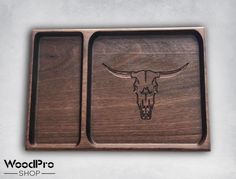 a wooden tray with a longhorn skull on the front and bottom, inlayed to wood