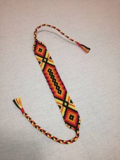 a colorful beaded lanyard on a white surface