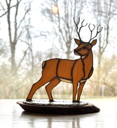 a stained glass deer standing on top of a table