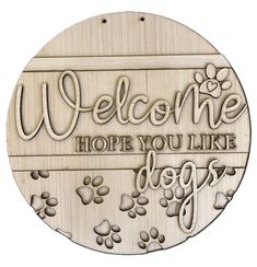 a wooden plaque with the words welcome, hope you like dogs and paw prints on it