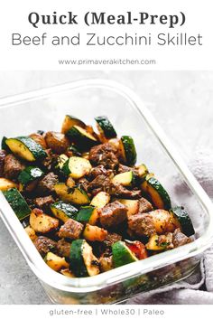 a glass container filled with beef and zucchini skillet on top of a table