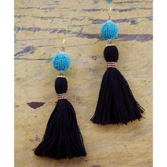 two black tasselled earrings with blue beads